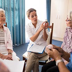Community nurse speaking to elderly patients